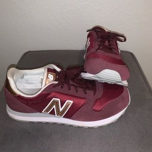 New Balance maroon and gold shoes